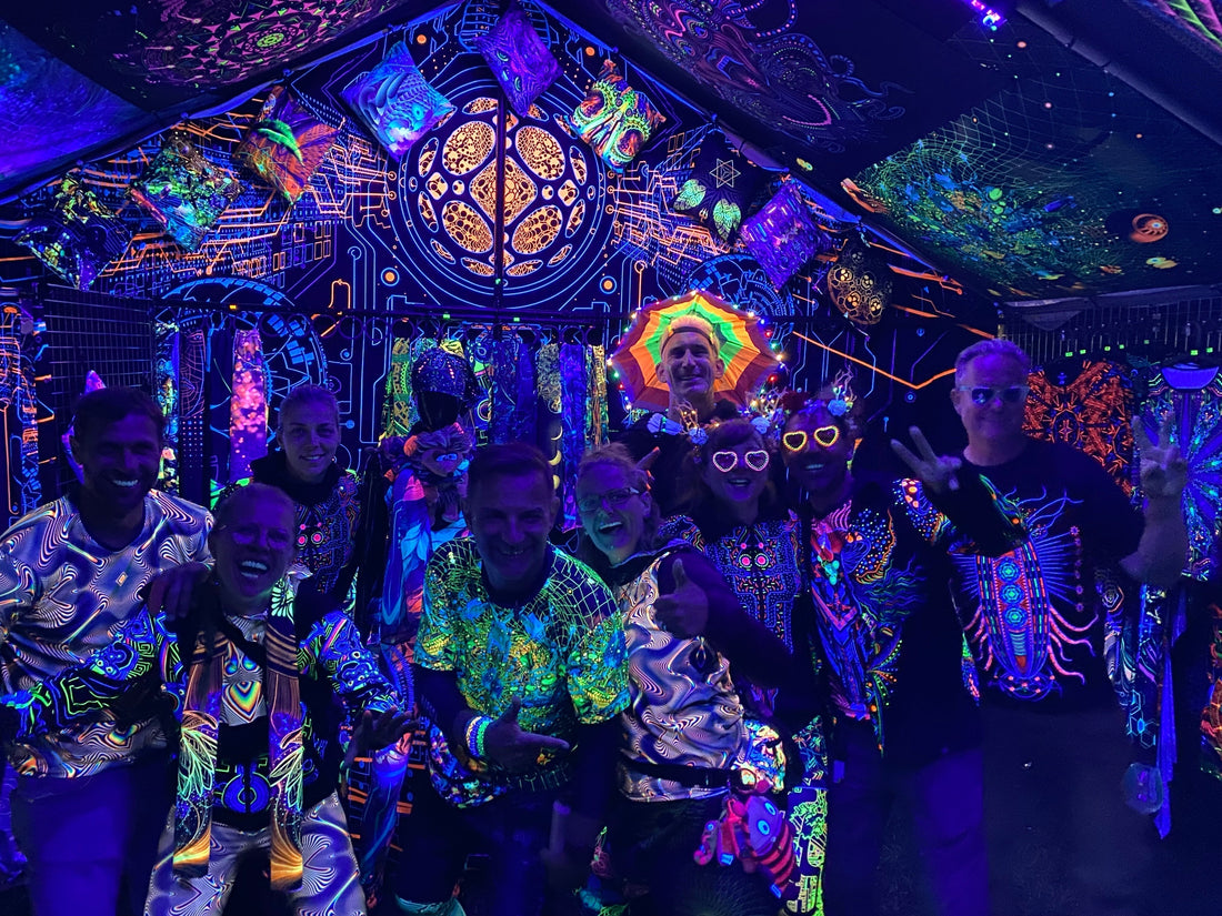 A group of people wearing uvreactive clothing at a psytrance festival