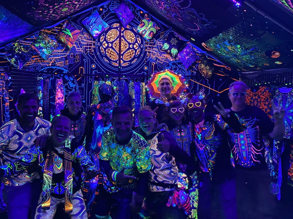 A group of people wearing uvreactive clothing at a psytrance festival