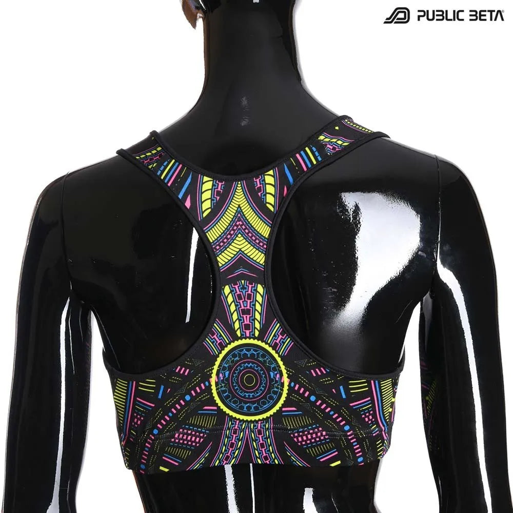 Active top with geometric UV-reactive graphics, photographed in natural light