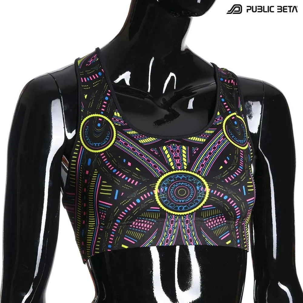 Active top with geometric UV-reactive graphics, photographed in natural light