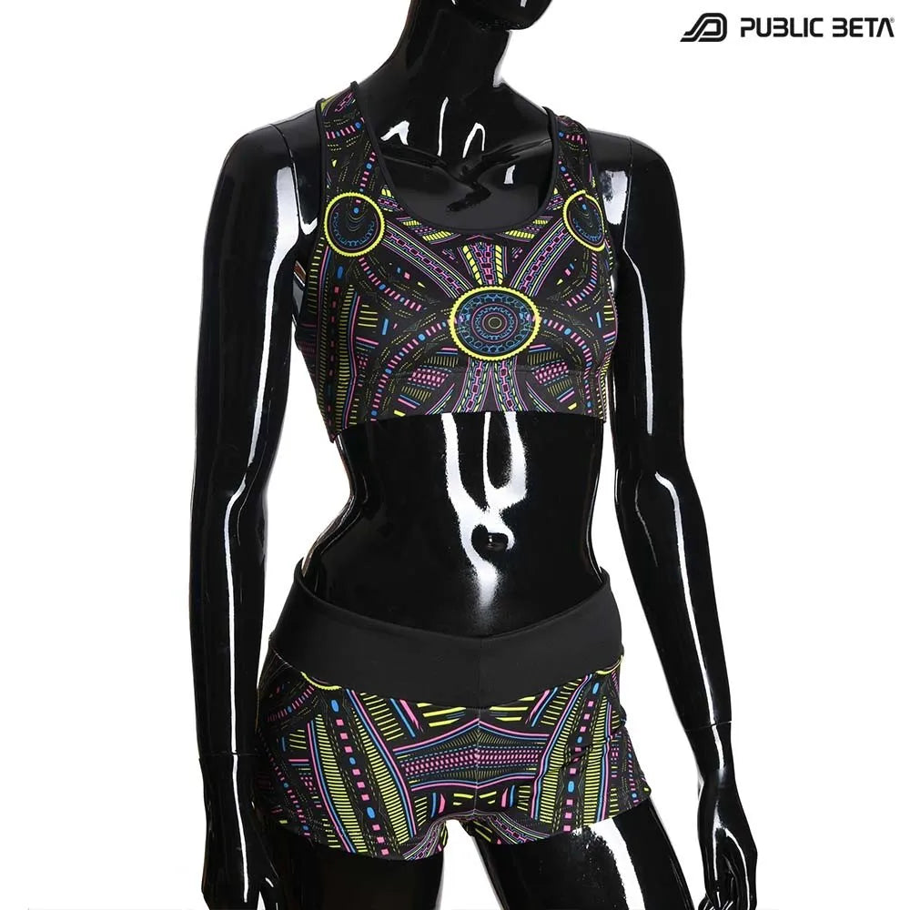 Active top with geometric UV-reactive graphics, photographed in natural light