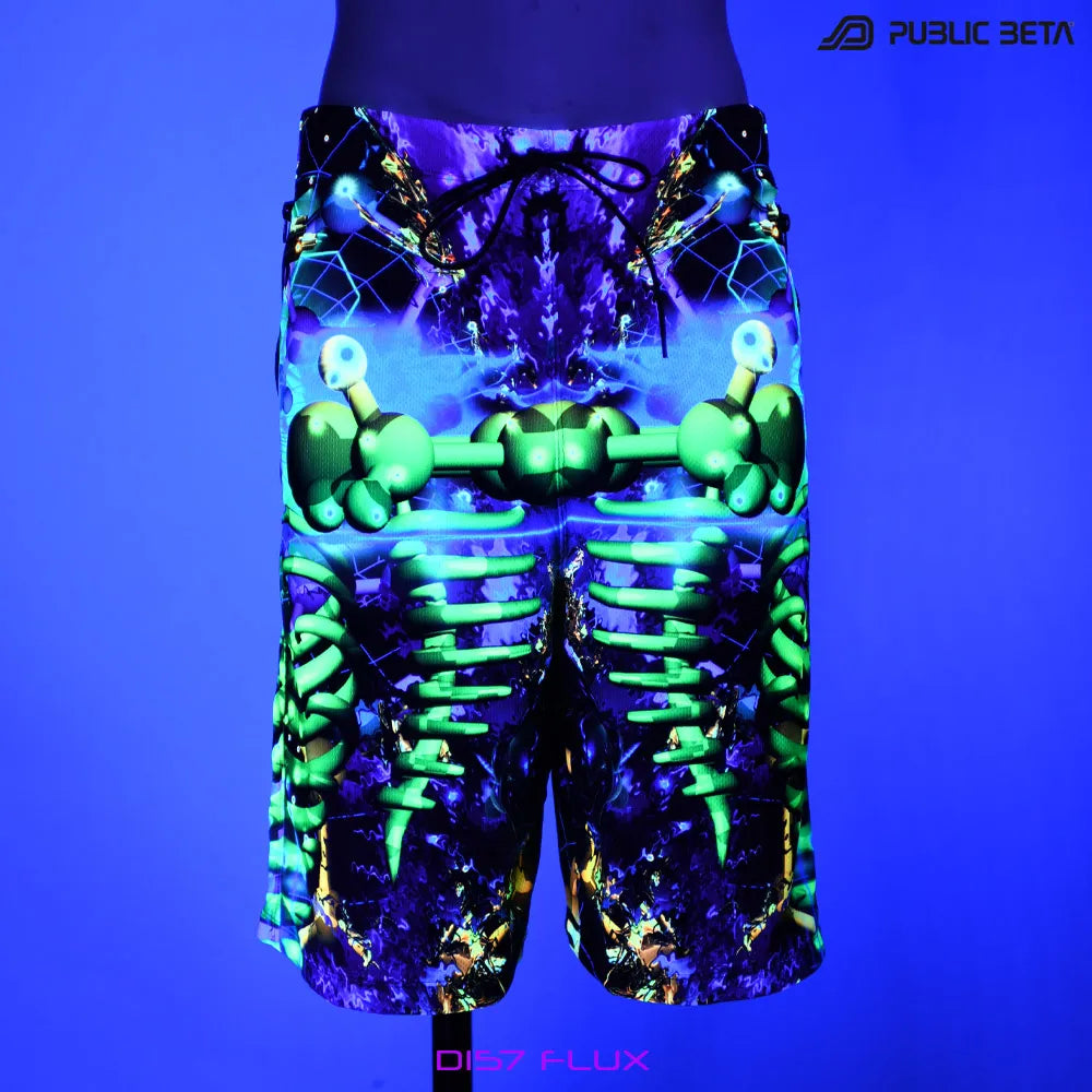 Boardshorts with UV-reactive psychedelic print glowing under blacklight