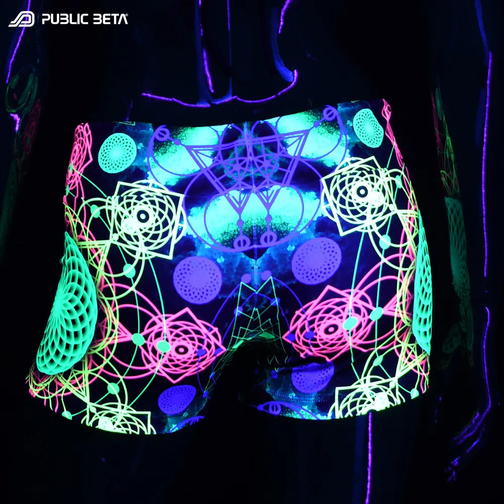 Shorts women with UV-reactive psychedelic graphics glowing under blacklight back