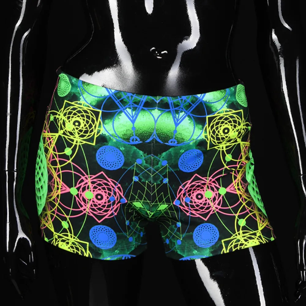 Shorts women with UV-reactive printed psychedelic graphics, photographed in natural light front view