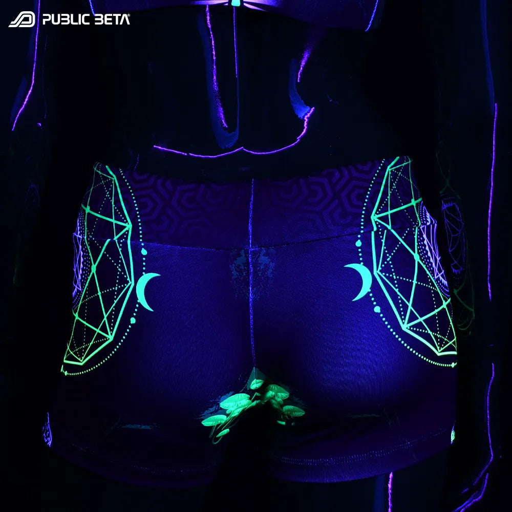 Shorts women with UV-reactive psychedelic graphics glowing under blacklight