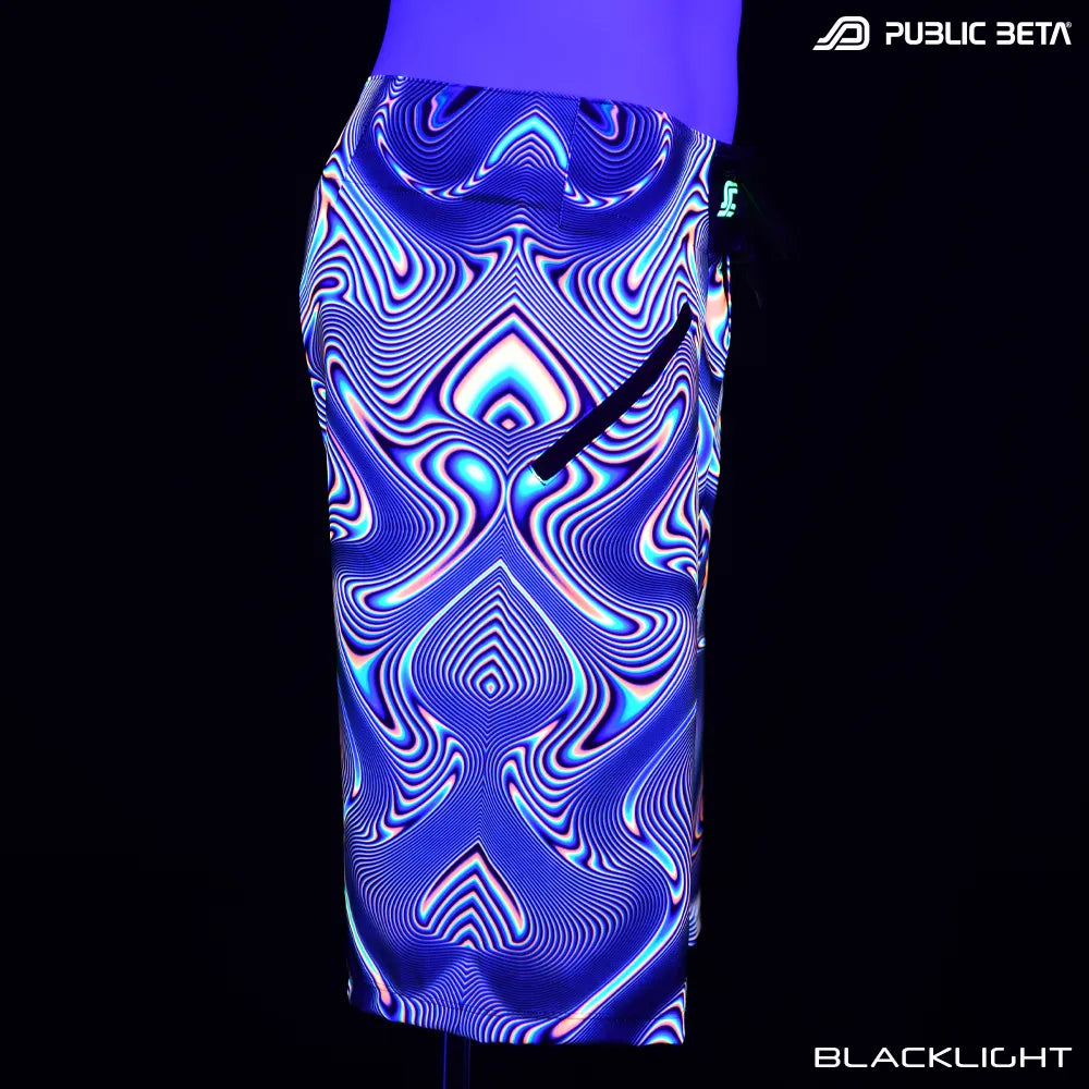 Boardshorts with UV-reactive psychedelic art print glowing under blacklight