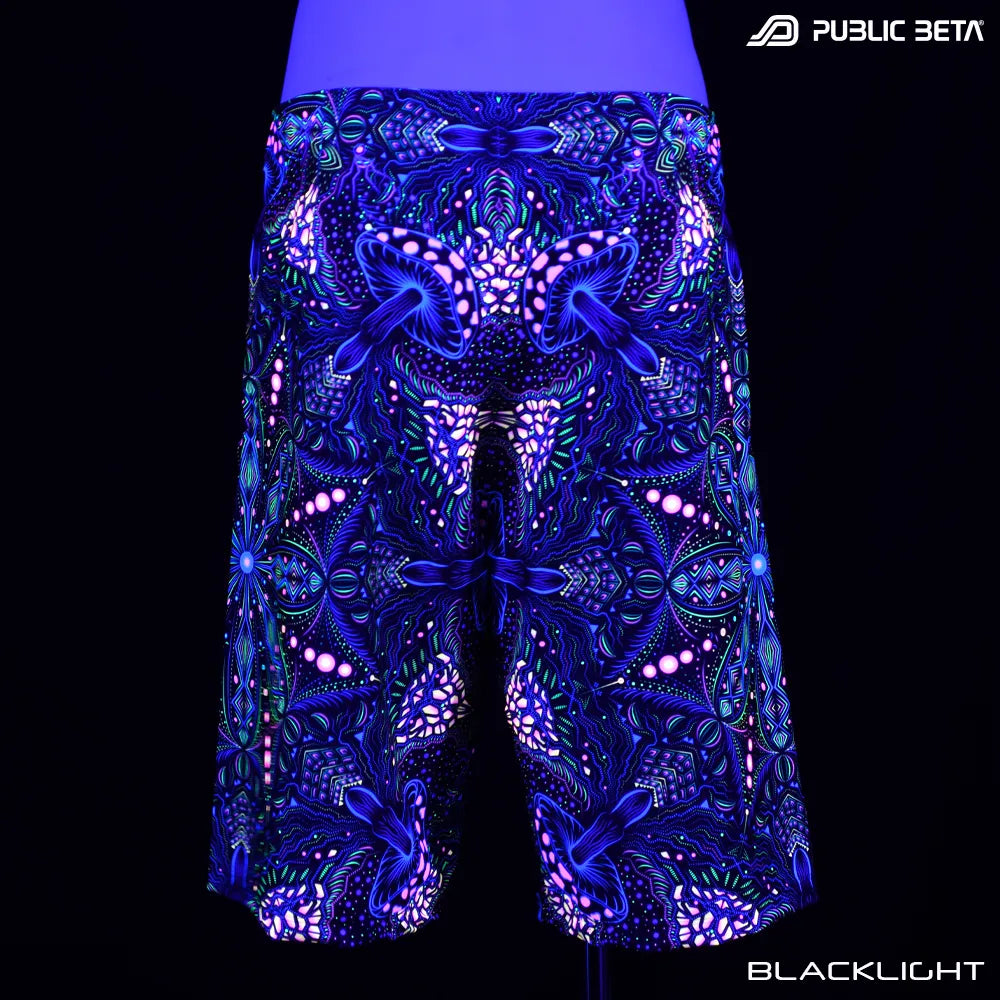Boardshorts with organic UV-reactive print glowing under blacklight