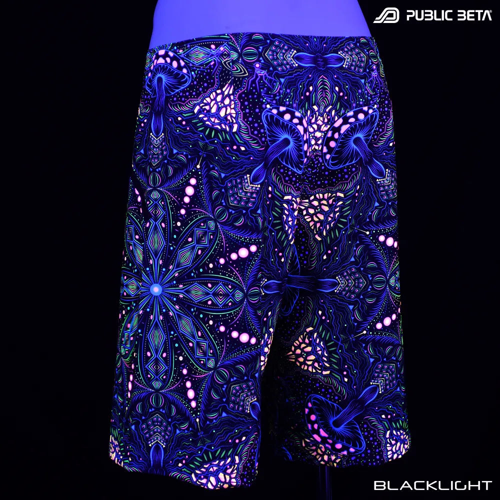 Boardshorts with organic UV-reactive print glowing under blacklight
