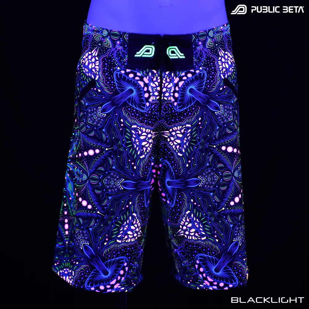 Boardshorts with organic UV-reactive print glowing under blacklight