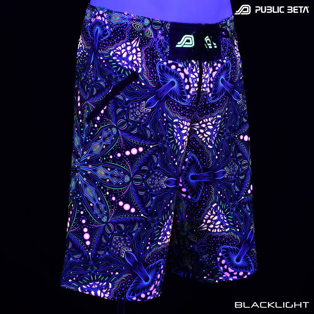 Boardshorts with organic UV-reactive print glowing under blacklight