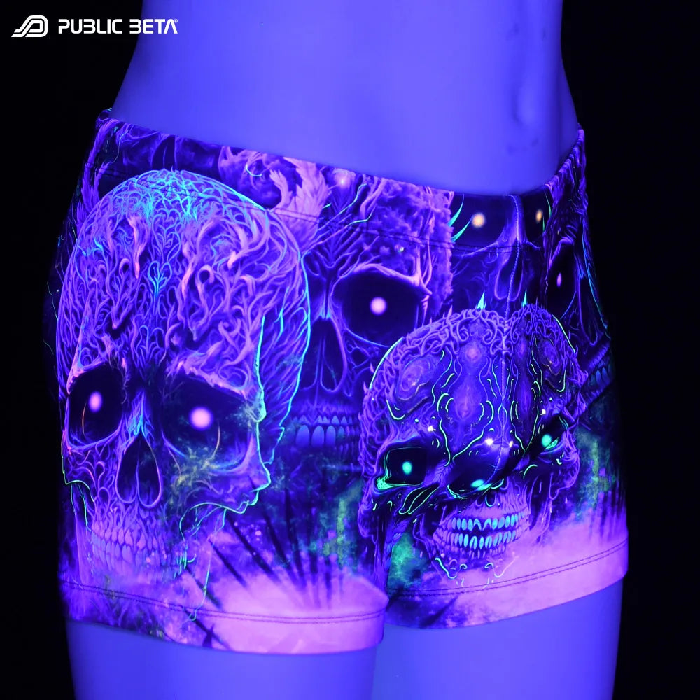 Swim shorts with UV-reactive futuristic print glowing under blacklight