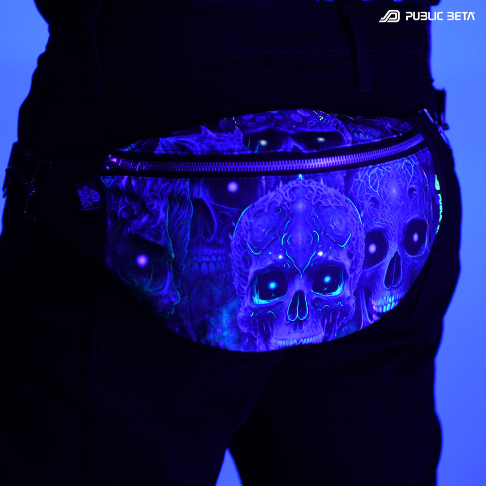 Bum bag with blue tribal skulls print glowing under blacklight