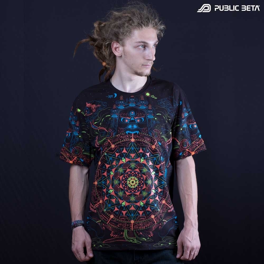 Model wearing a T-shirt with geometric UV-reactive graphics, photographed in natural light