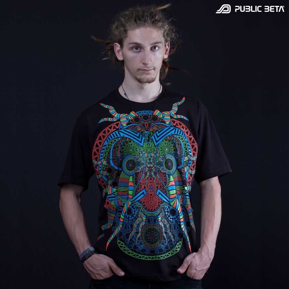 Model wearing a t-shirt with UV-reactive psychedelic art print, photographed in natural light