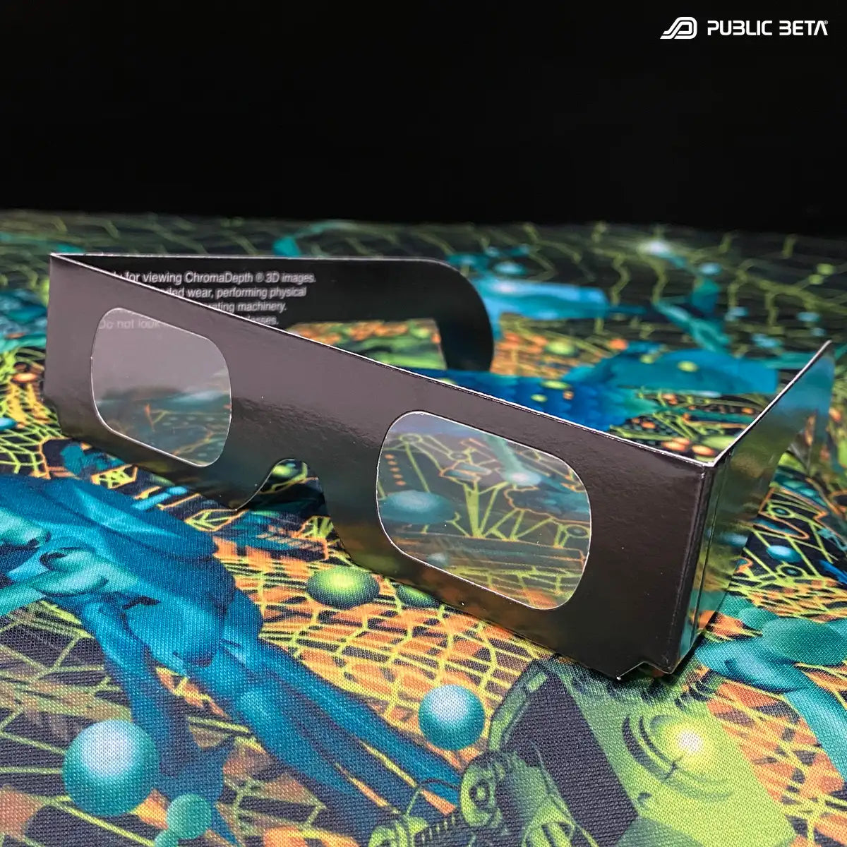  Pair of ChromaDepth paper 3D glasses displayed on a colorful 3D artwork
